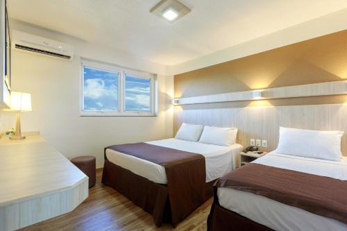 
Cama ou camas em um quarto em Luz Hotel

