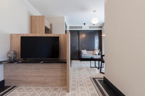 a living room with a large flat screen tv at La Falconeria Hotel in Valletta