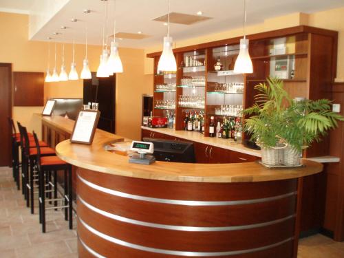 a bar in a restaurant with some pendant lights at La Table Alsacienne in Farébersviller