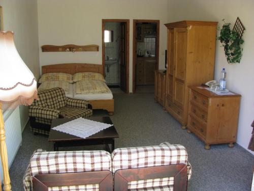 a living room with a bed and a couch at Penzion 102 in Pardubice