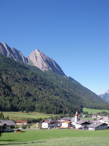 a village with a mountain in the background at Unterbergerhof in Val di Vizze