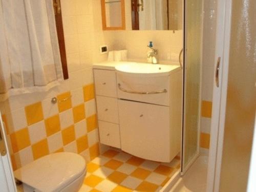 a bathroom with a sink and a toilet at Lignano Pineta very nice in Lignano Sabbiadoro