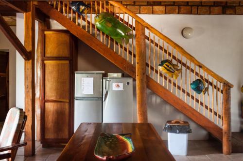 a kitchen with a refrigerator and a staircase at Bay View Lodge in Miramar