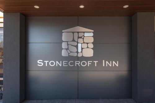 a sign on the side of a building at Stonecroft Inn in Windsor