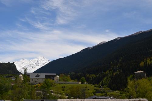 a town in a valley with mountains in the background at Hotel Svanseti in Mestia