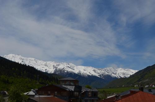 a mountain range with snow covered mountains in the distance at Hotel Svanseti in Mestia