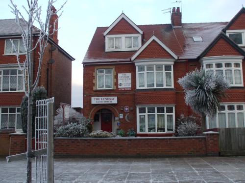 a red brick house with a gate in front of it at The Lyndsay Guest House in Skegness