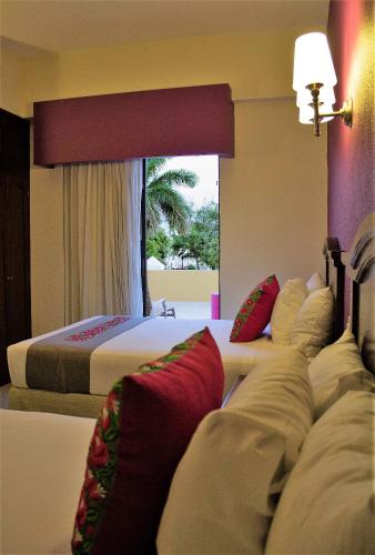 Una cama o camas en una habitación de Hotel Plaza Campeche