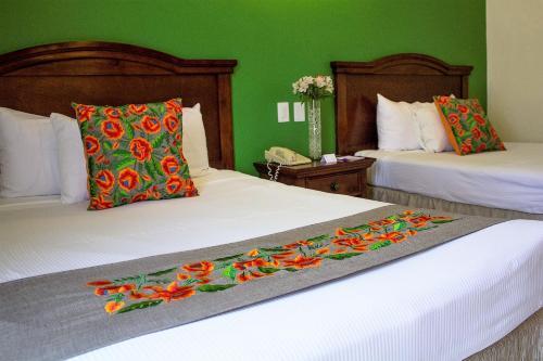 Una cama o camas en una habitación de Hotel Plaza Campeche