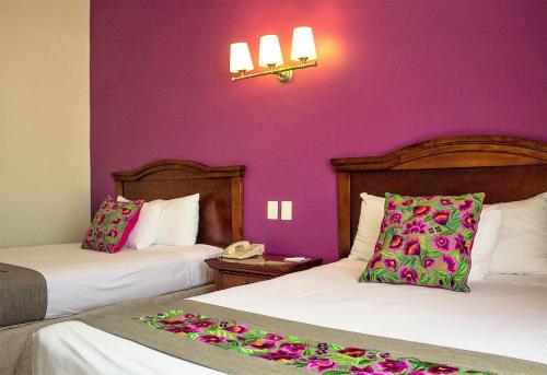 Una cama o camas en una habitación de Hotel Plaza Campeche