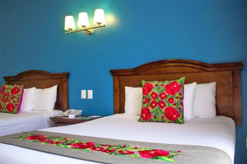 Una cama o camas en una habitación de Hotel Plaza Campeche