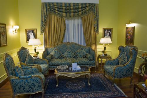 a living room with a couch and two chairs at Helnan Auberge Fayoum in Fayoum Center