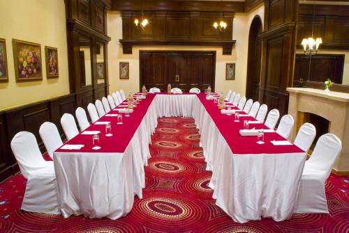 a long table with red and white tables and chairs at Helnan Auberge Fayoum in Fayoum Center
