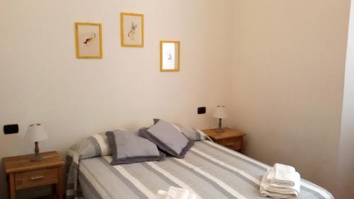 a bedroom with a bed with two night stands and two lamps at Da Iole in La Spezia