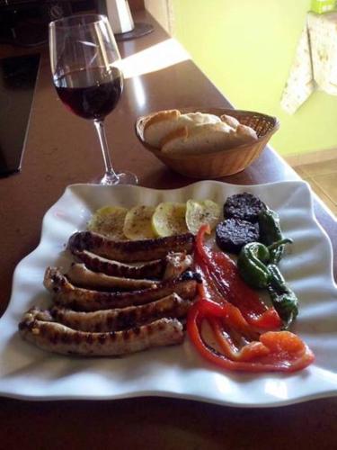 a white plate of food with a glass of wine at La Contrada in Arens de Lledó