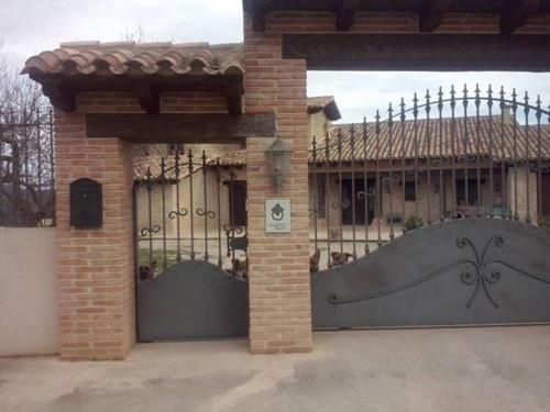 a gate to a house with a large metal gate at La Contrada in Arens de Lledó