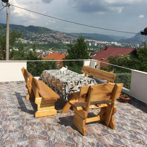 a table and chairs on a patio with a view at Apartment Sena in Sarajevo
