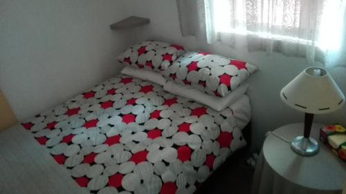 a small bedroom with a bed with hearts on it at 18 on Barnard in Port Elizabeth