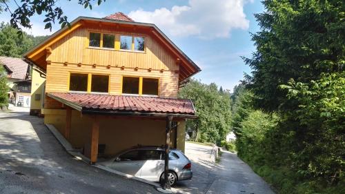 a car parked in front of a house at Apartments Bernarda in Bled