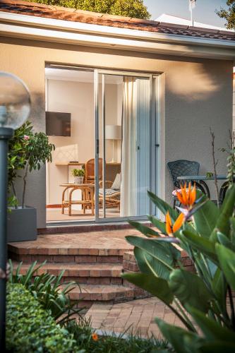 a house with a sliding glass door leading to a patio at Maroela House Guest Accommodation in Bellville