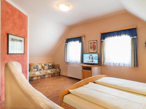 a bedroom with a bed and a couch at Landhof Steinbäck in Sankt Stefan ob Stainz
