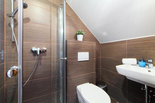 a bathroom with a shower and a toilet and a sink at Arácsi Vendégház in Balatonfüred