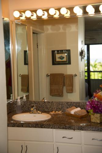 a bathroom with a sink and a large mirror at Wailea Sunset Condo - Ekolu #607 in Wailea