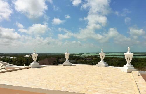 a roof with four white statues on top of it at Ocean West Boutique Hotel in Nassau