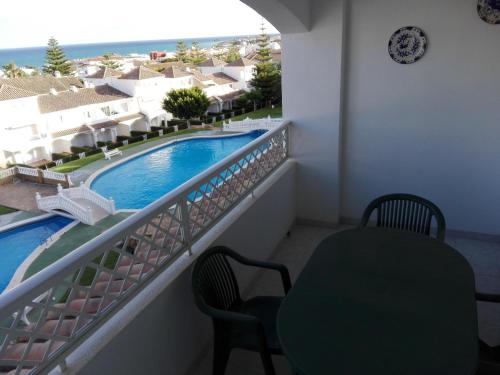 a balcony with a view of a swimming pool at APCOSTAS - Complejo Al Andalus in Alcossebre