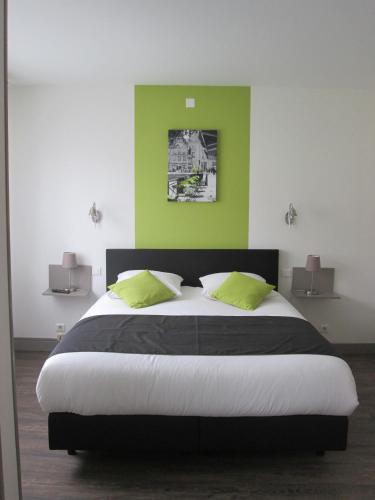 a bedroom with a large bed with green walls at Auberge en Ardenne in Les Hautes-Rivières