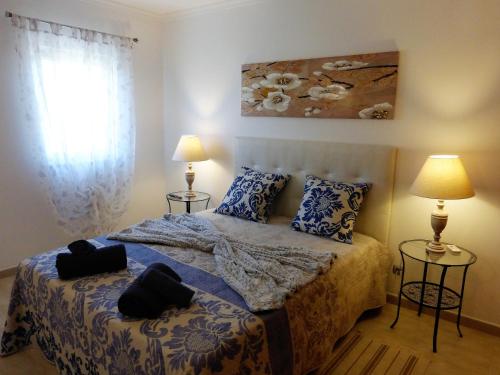 ラゴスにあるLucas' Houseのベッドルーム1室(ベッド1台、ランプ2つ、窓付)