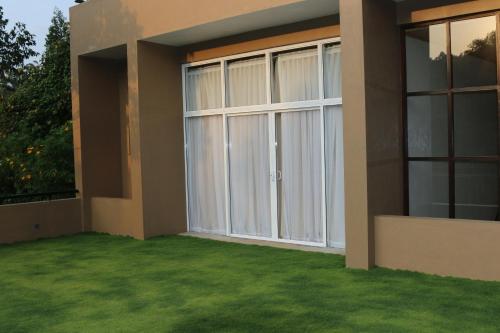 a house with a large sliding glass door at Lilara Hills - Diyatalawa in Diyatalawa