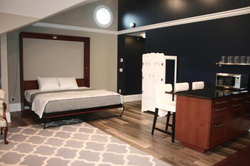 a bedroom with a bed and a table and a microwave at Anchor Inn Boutique Hotel in Put-in-Bay