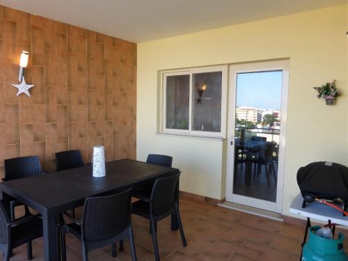 a dining room with a table and chairs and a window at Lucas' House in Lagos