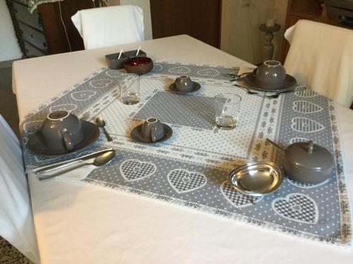 a table with a table cloth with tea sets on it at BnB Trento in Trento