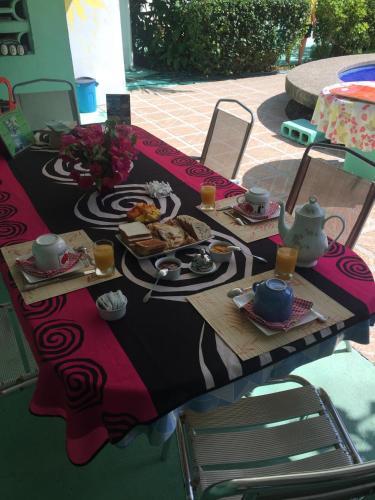a table with food and tea on top of it at La Perlita in Jacó