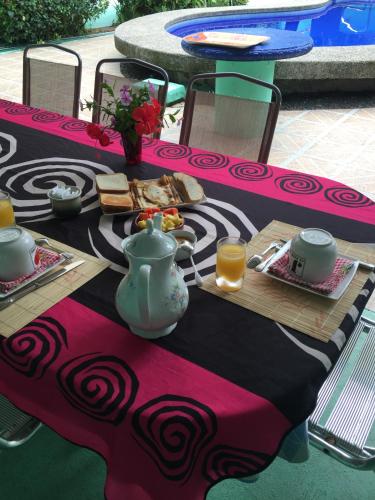 a table with a table cloth with food on it at La Perlita in Jacó