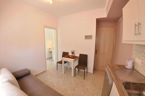 a living room with a couch and a table at Angels Pool Studios and Apartments in Paleokastritsa