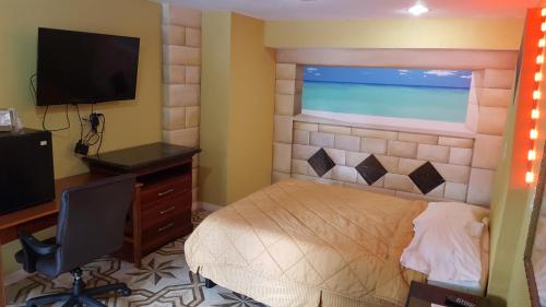 a bedroom with a bed and a desk and a television at Budget Motel in Orlando