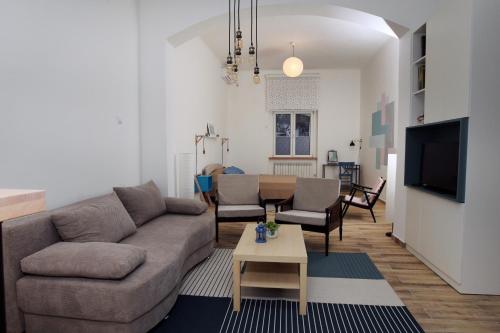 a living room with a couch and a table at Blue Box Apartment in Belgrade