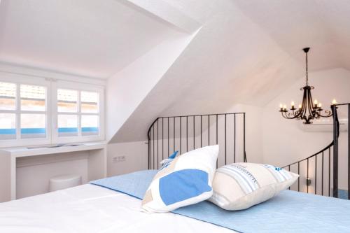 a bedroom with a bed with a chandelier at Villa Riva in Jelsa