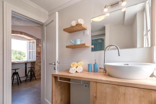 a bathroom with a sink and a mirror at Villa Riva in Jelsa