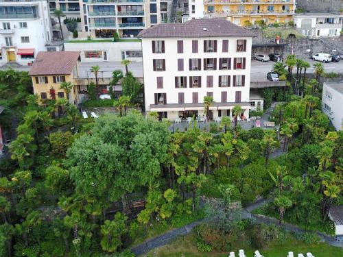 an aerial view of a city with buildings and trees at Hotel Garni Rivabella au Lac in Brissago