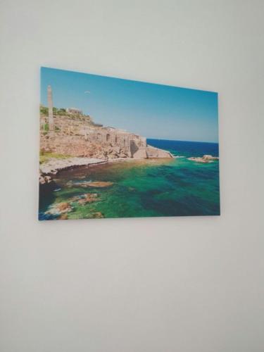 a framed picture of the ocean with a pyramid at Casamia in Portopalo
