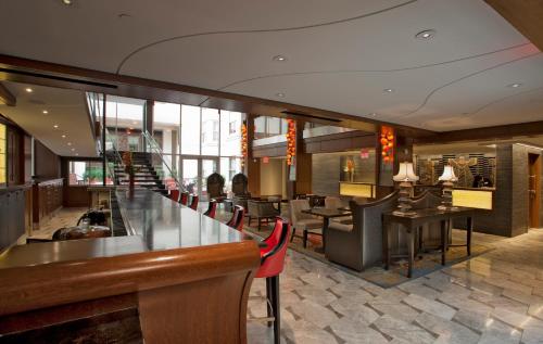 a restaurant with a bar and tables and chairs at Morrison Clark Inn Washington DC Convention Center in Washington