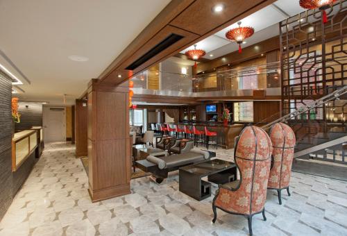 a lobby with a bar with chairs and a couch at Morrison Clark Inn Washington DC Convention Center in Washington