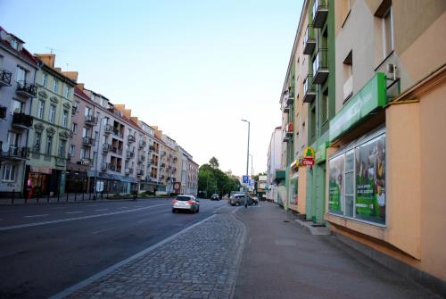 a city street with cars driving down the street at Apartament Zwycięstwa 98 in Koszalin