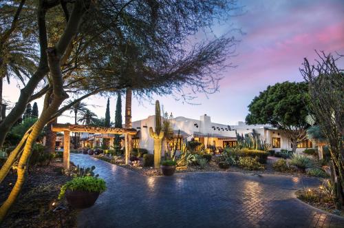 a villa with a pool in the middle of a garden at The Wigwam in Litchfield Park