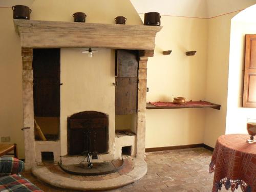 a stone fireplace in the corner of a room at Residence Il Palazzo in Santo Stefano di Sessanio