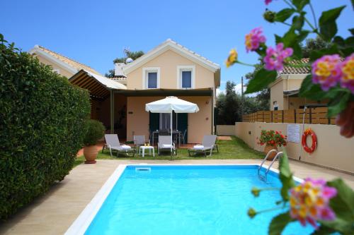 a villa with a swimming pool and a house at Kydonies Villas in Lefkada Town